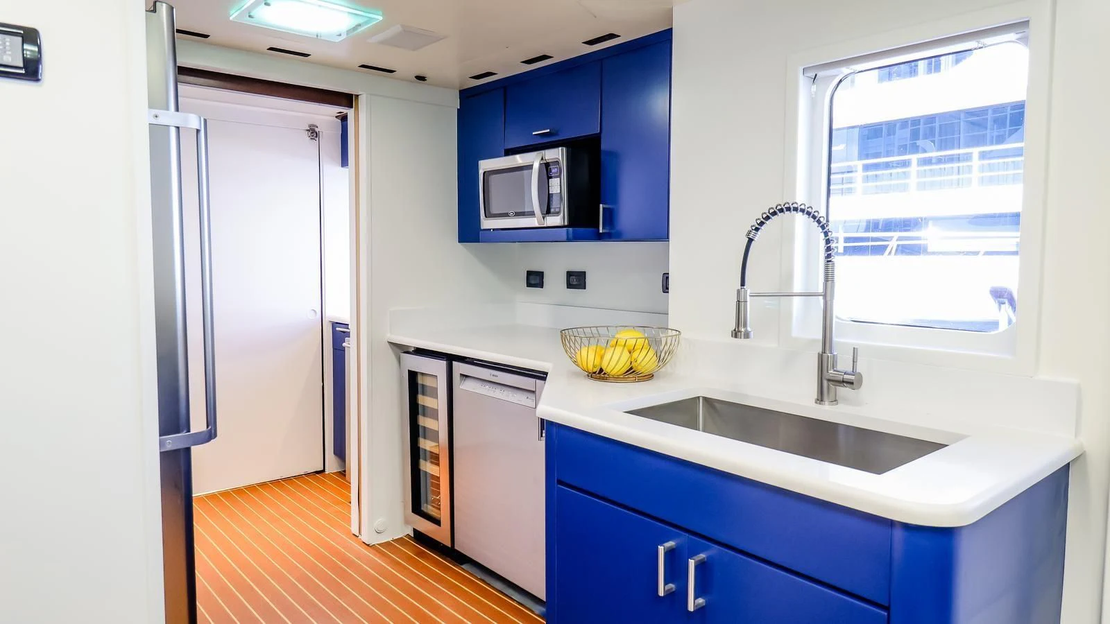 a kitchen with blue cabinets aboard JUST ENOUGH Yacht for Charter