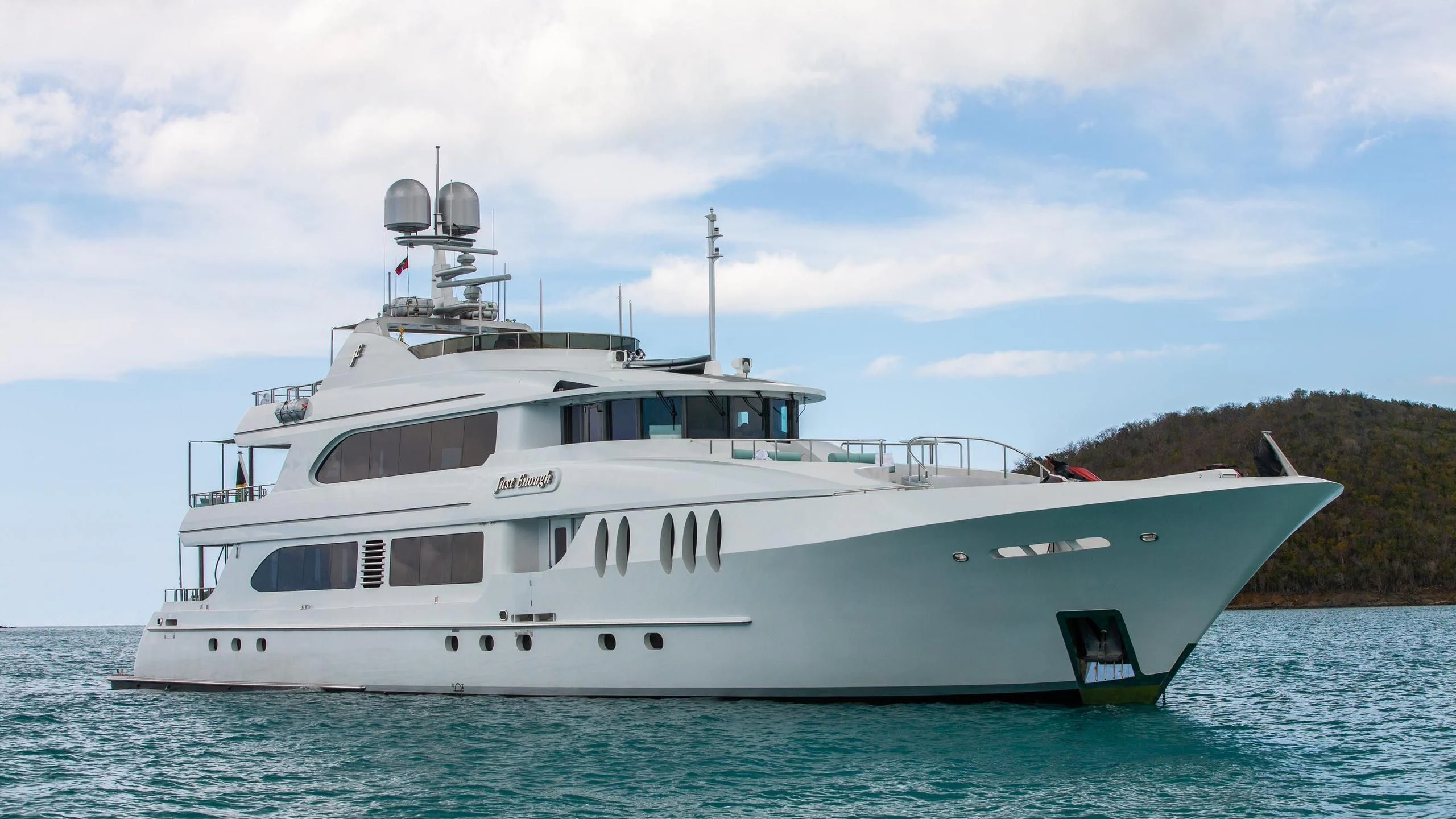 a large white boat in the water aboard JUST ENOUGH Yacht for Charter