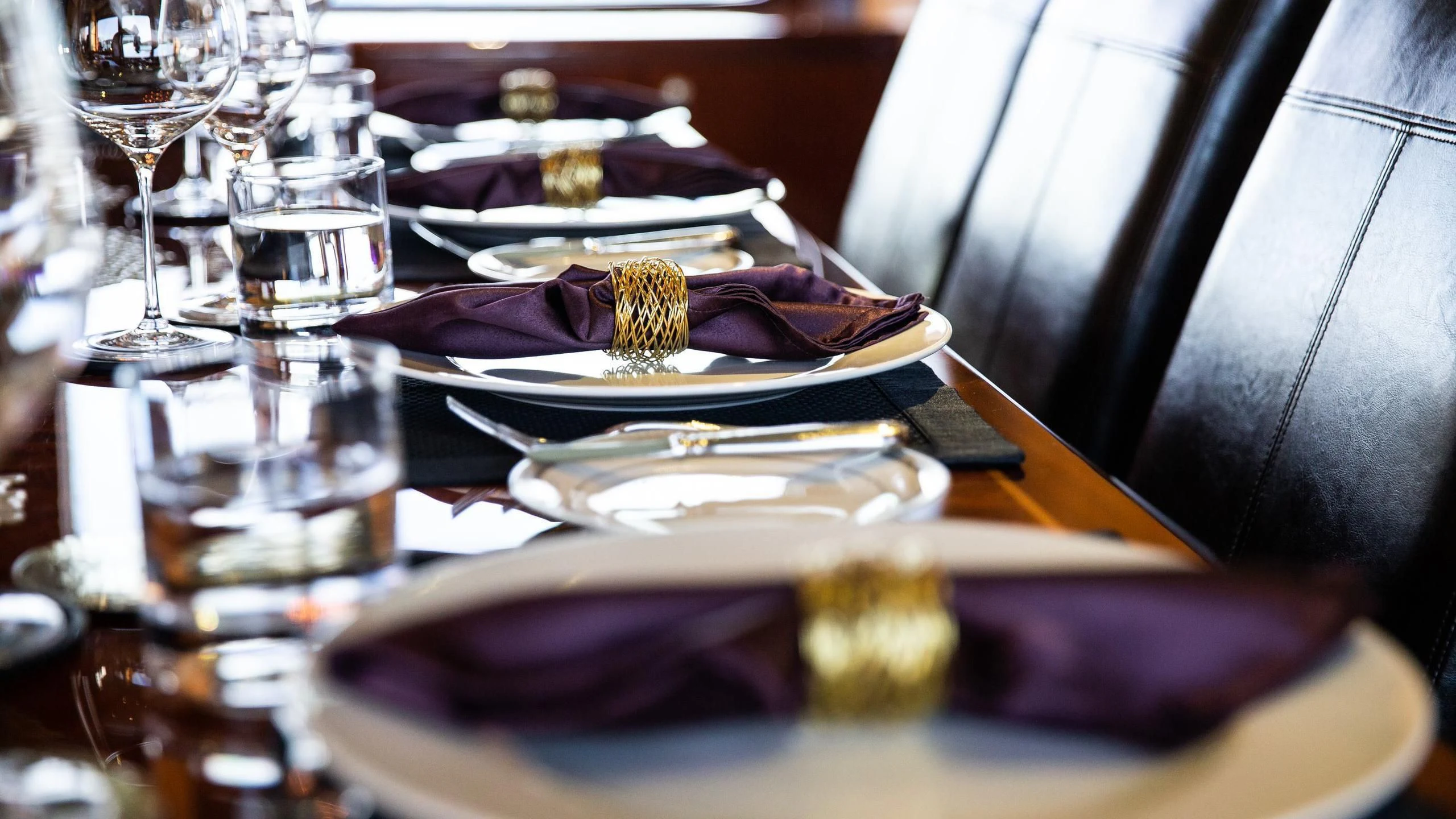 a plate of food and glasses aboard JUST ENOUGH Yacht for Charter