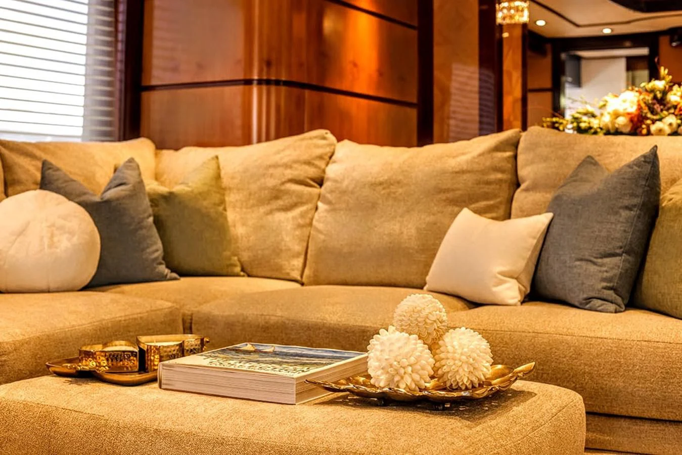 a couch with a coffee table and a glass of wine on it aboard JUST ENOUGH Yacht for Charter