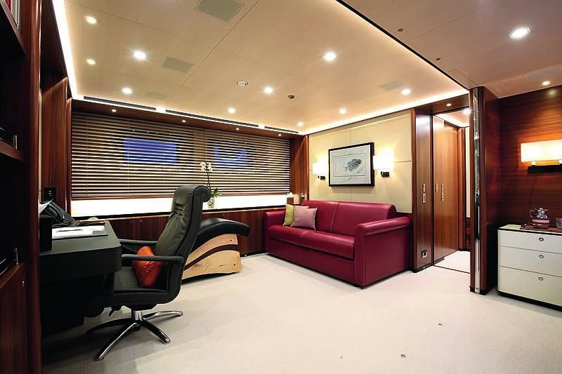 a living room with a couch and a desk aboard PERSEUS^3 Yacht for Sale