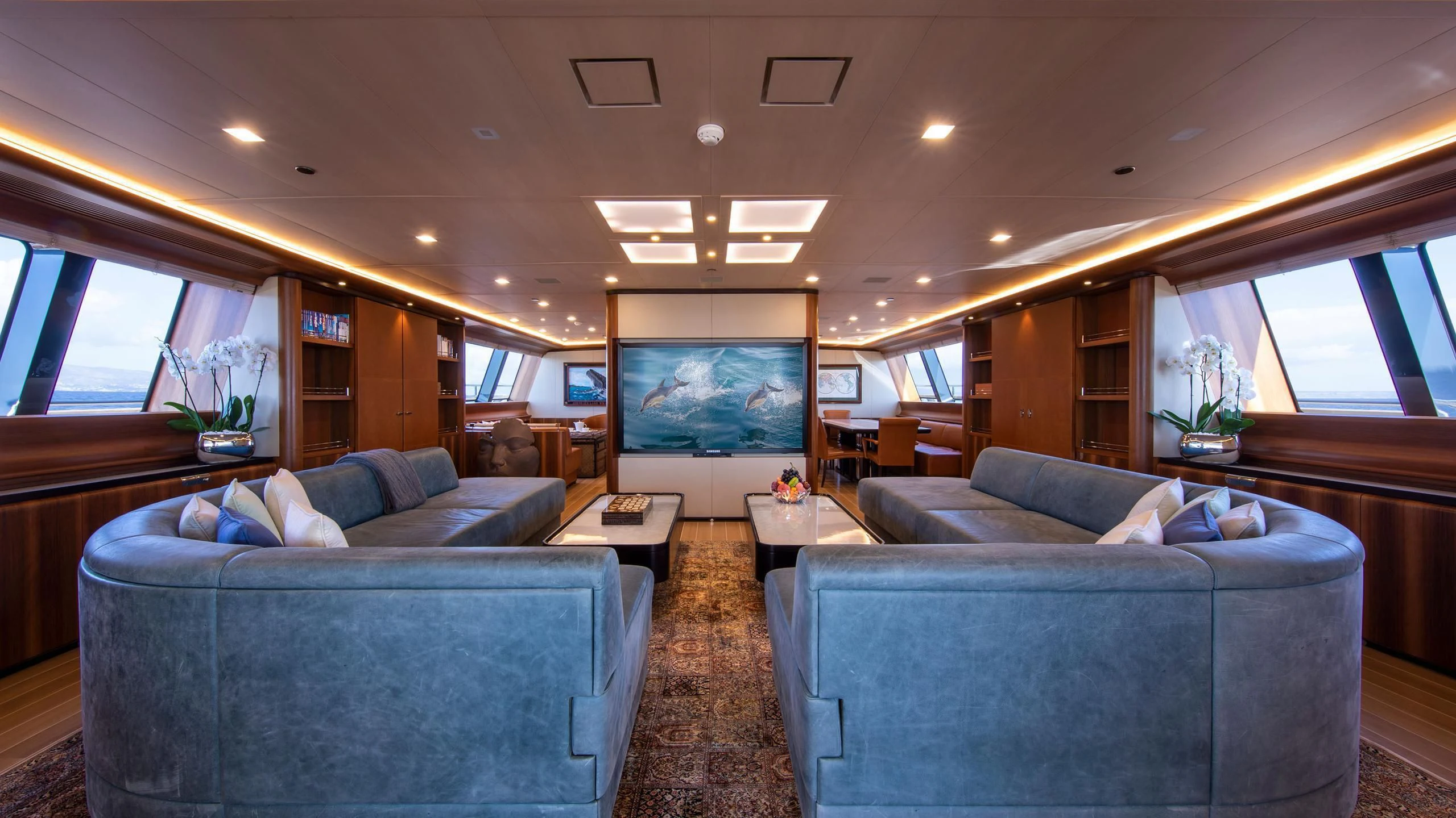 a living room with couches and a tv aboard PERSEUS^3 Yacht for Sale