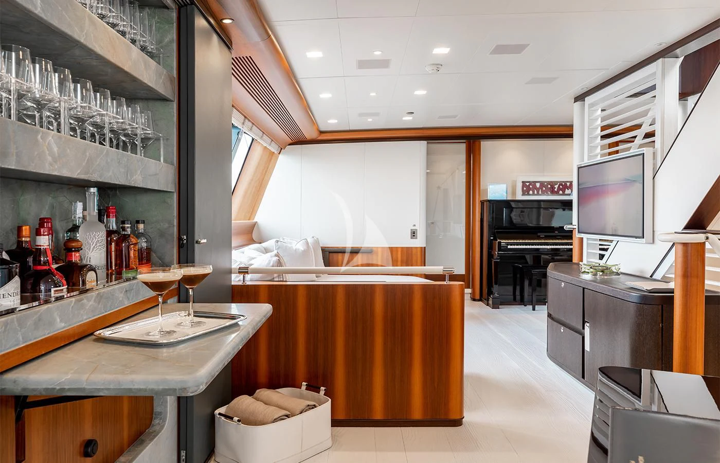 a large room with a bar and a tv aboard PERSEUS^3 Yacht for Sale