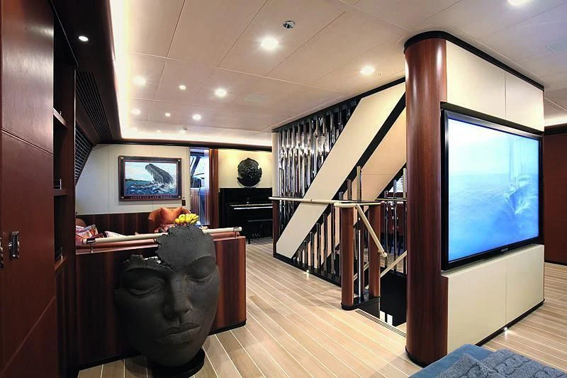 a room with a tv and a staircase aboard PERSEUS^3 Yacht for Sale