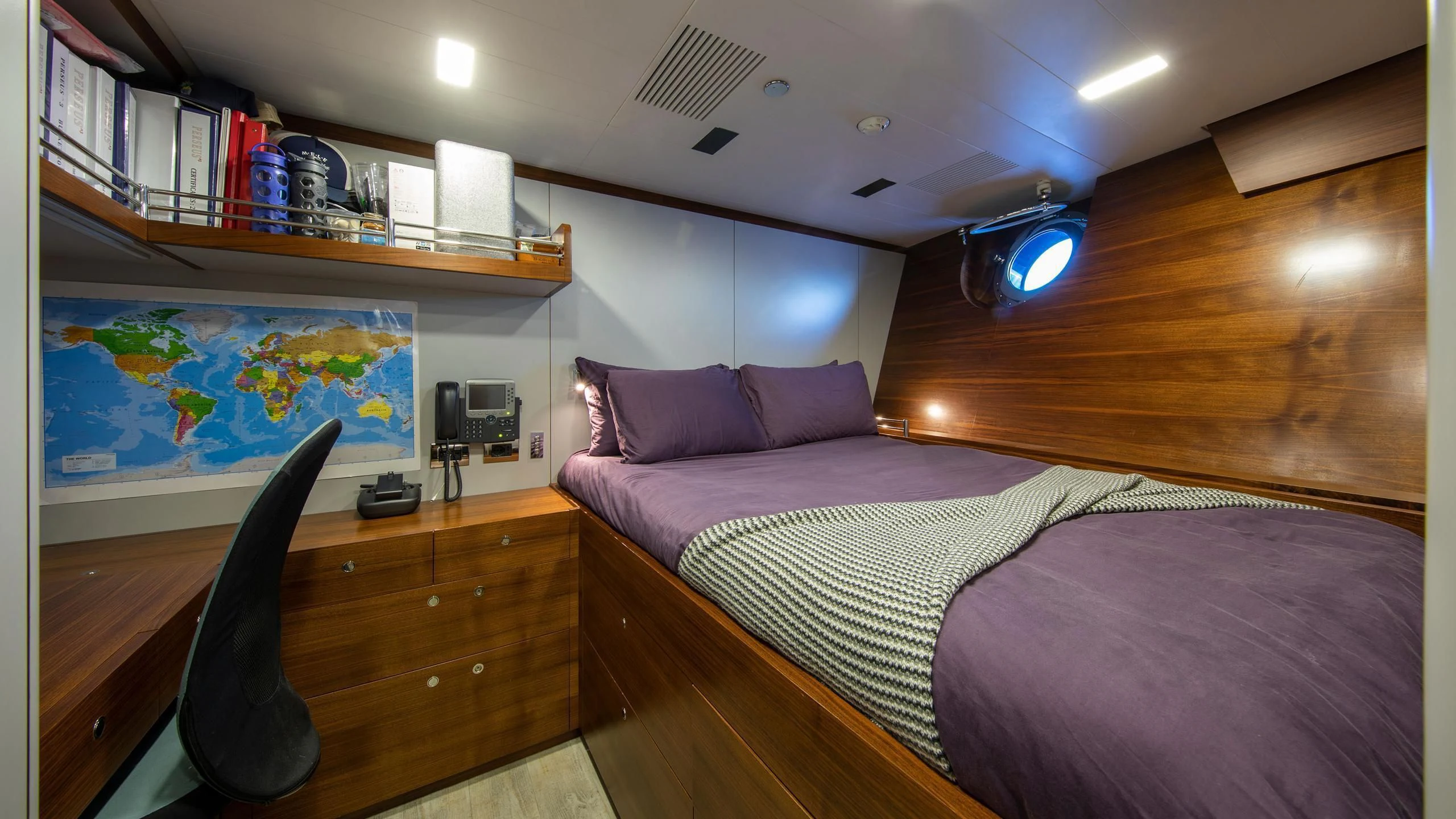 a bedroom with a bed and a desk aboard PERSEUS^3 Yacht for Sale