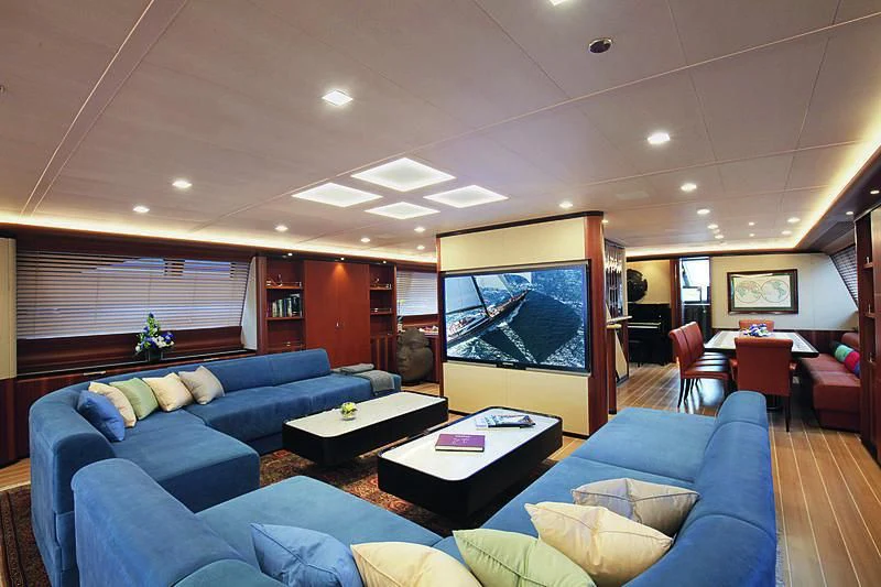 a living room with a large screen aboard PERSEUS^3 Yacht for Sale