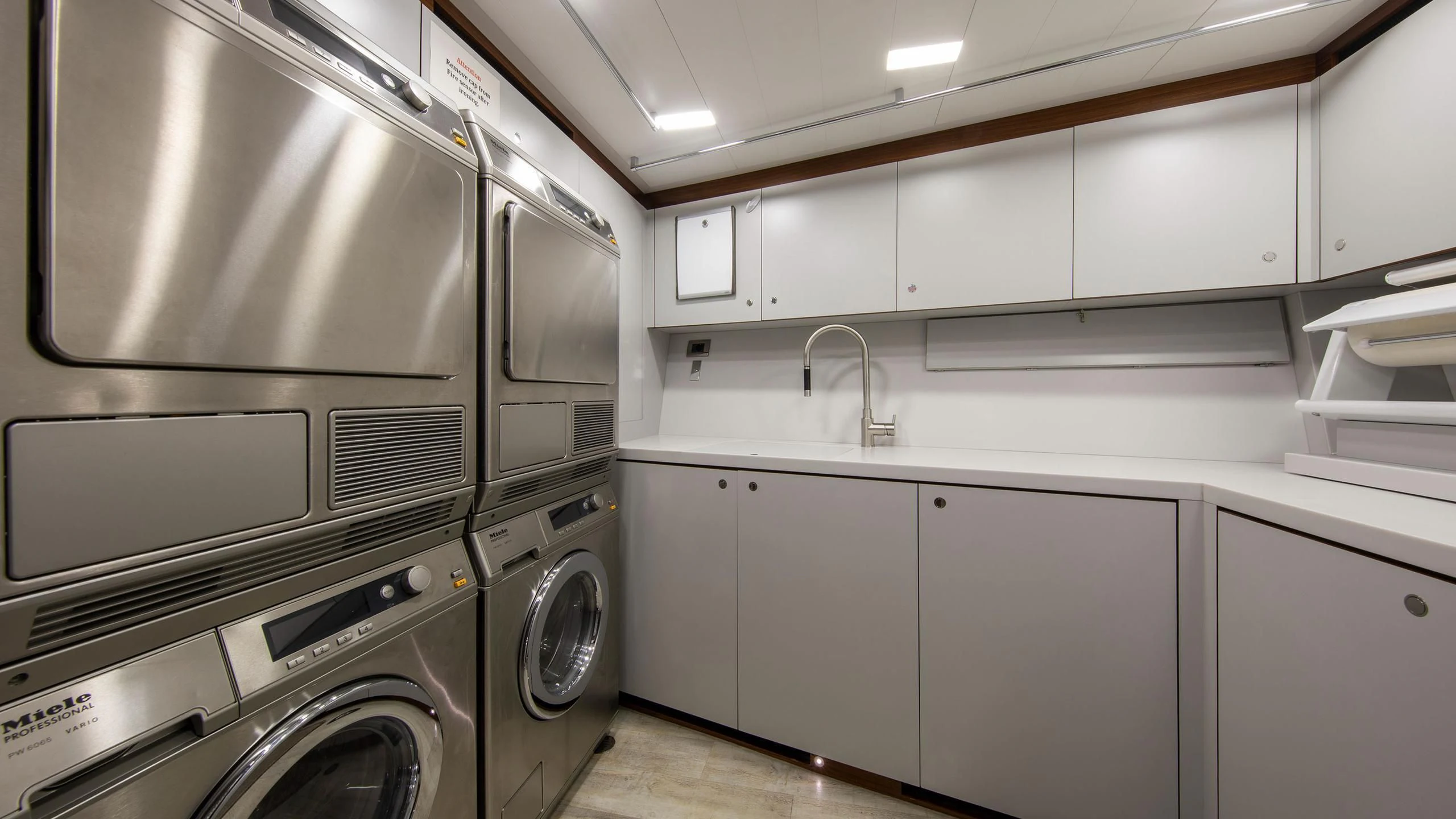 a kitchen with white cabinets aboard PERSEUS^3 Yacht for Sale