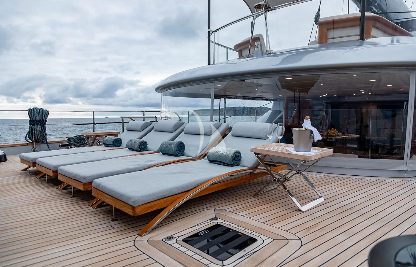 a deck with a large boat and a table on it aboard PERSEUS^3 Yacht for Sale
