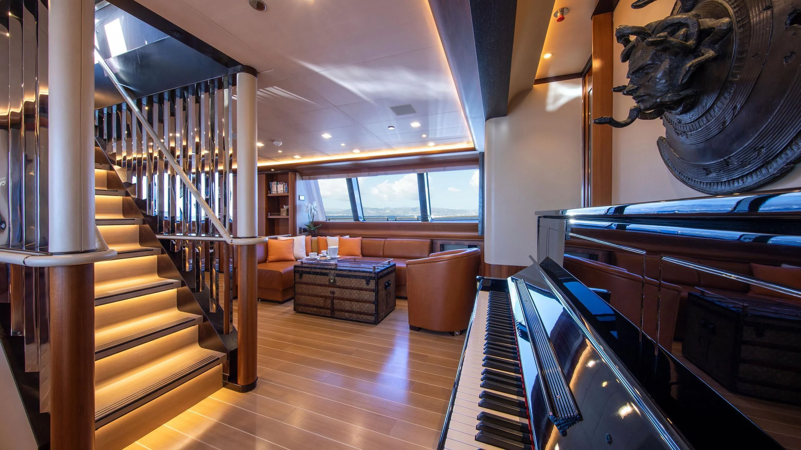 a room with a wood floor and a staircase aboard PERSEUS^3 Yacht for Sale