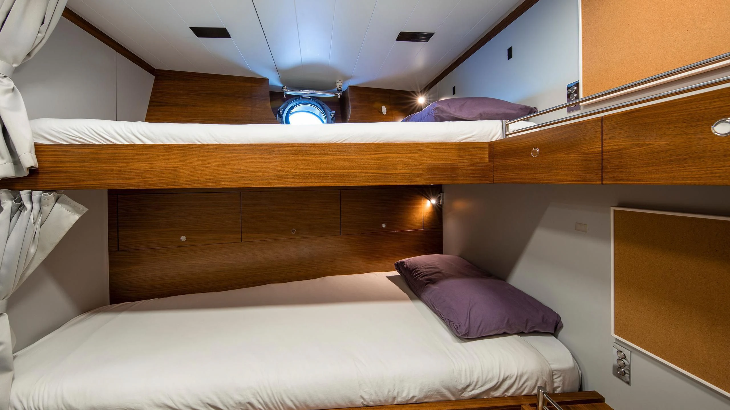 a bed with a white sheet and a wooden headboard aboard PERSEUS^3 Yacht for Sale