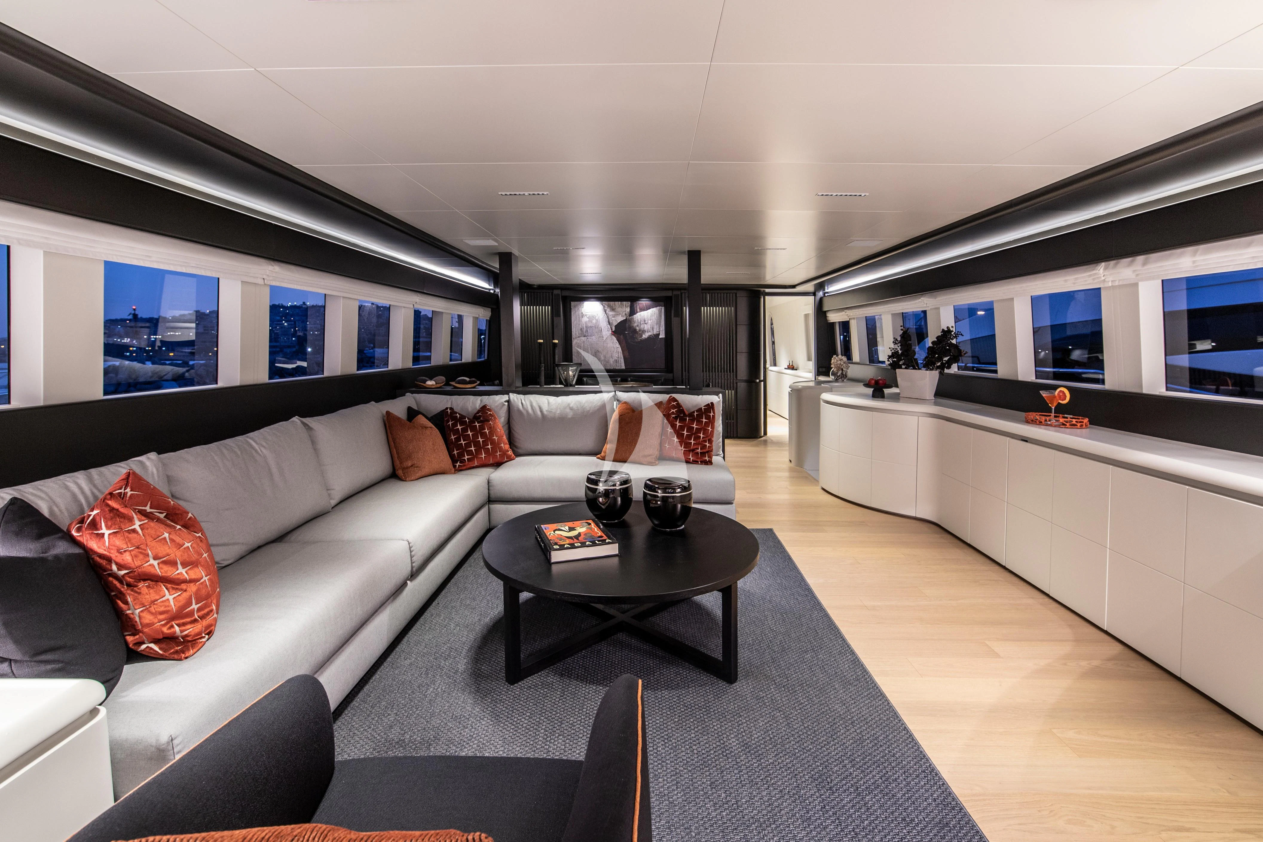 a living room with a large sofa aboard PROJECT STEEL Yacht for Sale