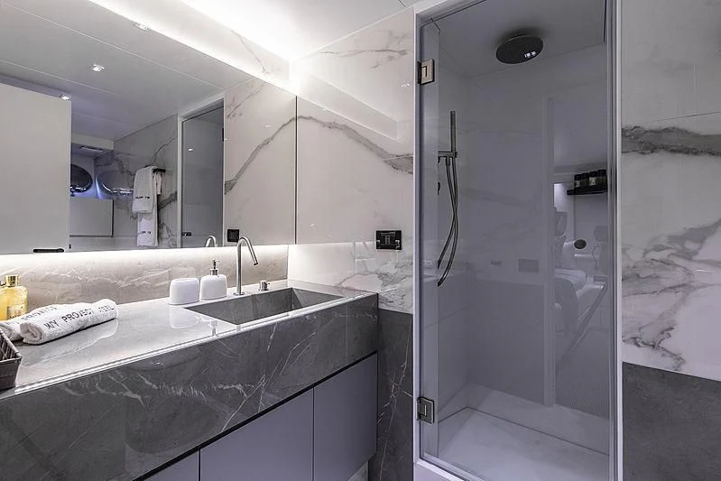 a bathroom with a large mirror aboard PROJECT STEEL Yacht for Sale