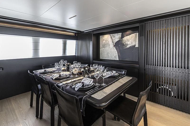 a dining table in a room aboard PROJECT STEEL Yacht for Sale