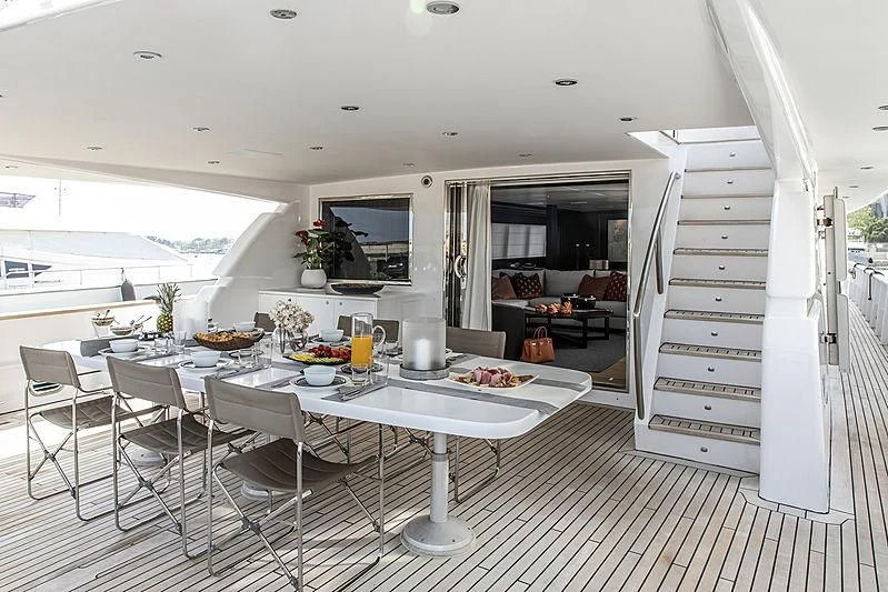a kitchen with a table and chairs aboard PROJECT STEEL Yacht for Sale