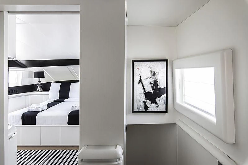 a bedroom with a picture on the wall aboard PROJECT STEEL Yacht for Sale