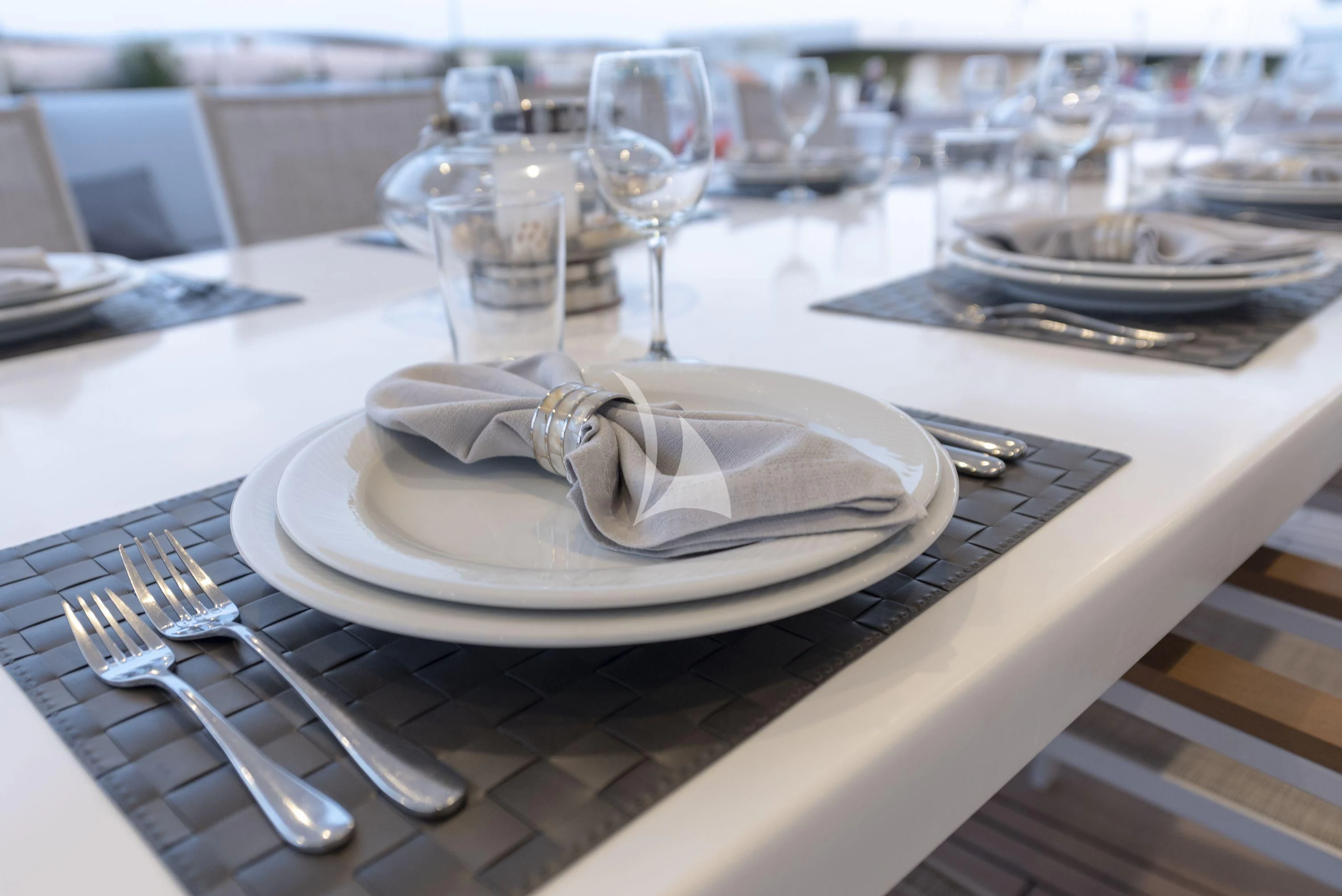 a table with plates and silverware aboard PROJECT STEEL Yacht for Sale