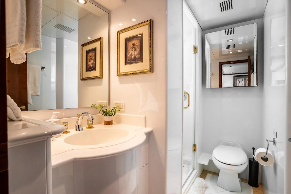 a bathroom with a sink toilet and a mirror aboard OUTTA TOUCH Yacht for Sale