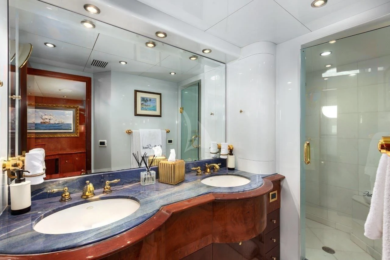 a bathroom with a countertop sink and a shower unit aboard OUTTA TOUCH Yacht for Sale