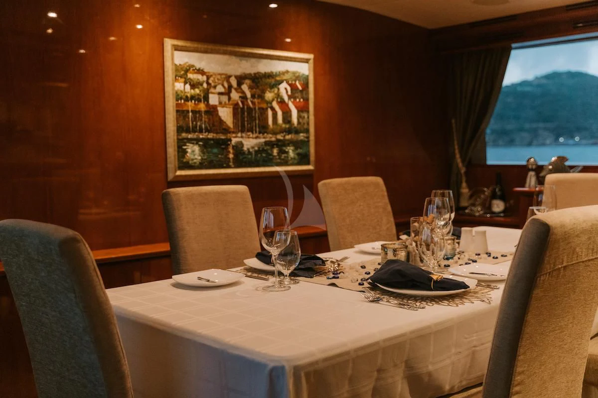 a table with a plate and glasses on it aboard OUTTA TOUCH Yacht for Sale