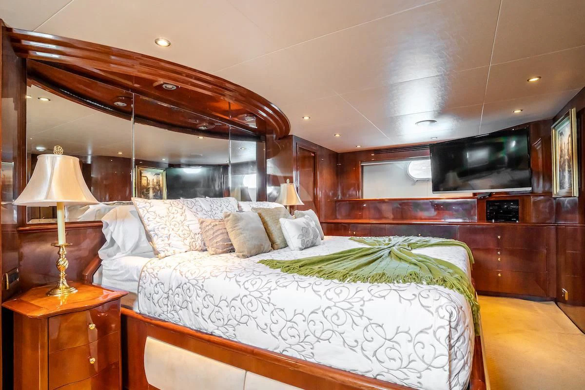a bedroom with a bed and a television aboard OUTTA TOUCH Yacht for Sale