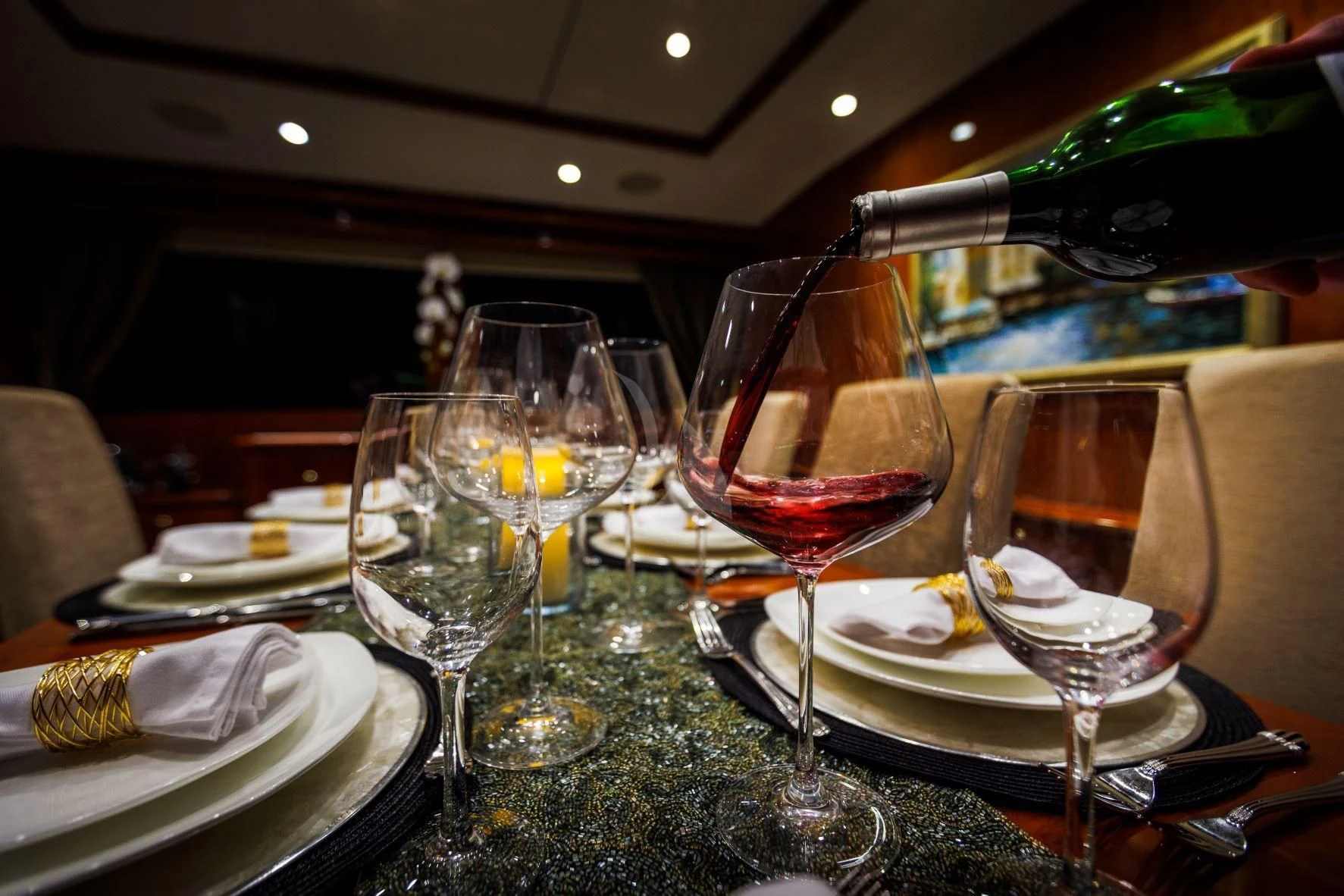 a table with wine glasses and plates aboard OUTTA TOUCH Yacht for Sale
