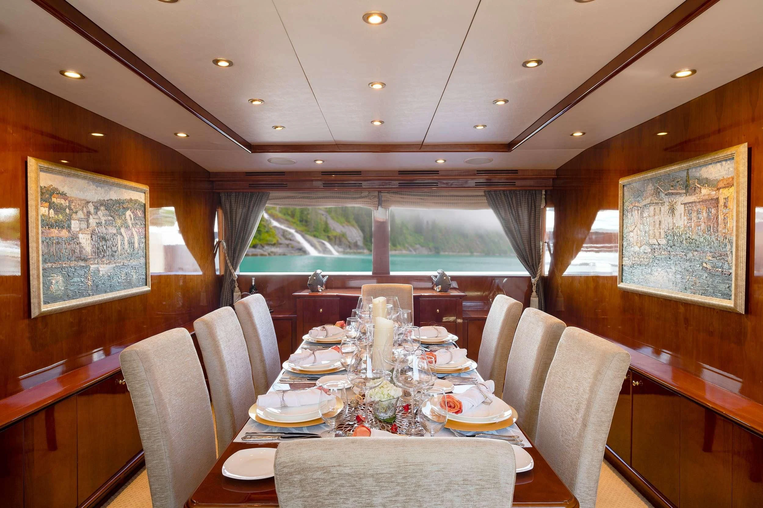 a dining room with a table set for a dinner aboard OUTTA TOUCH Yacht for Sale