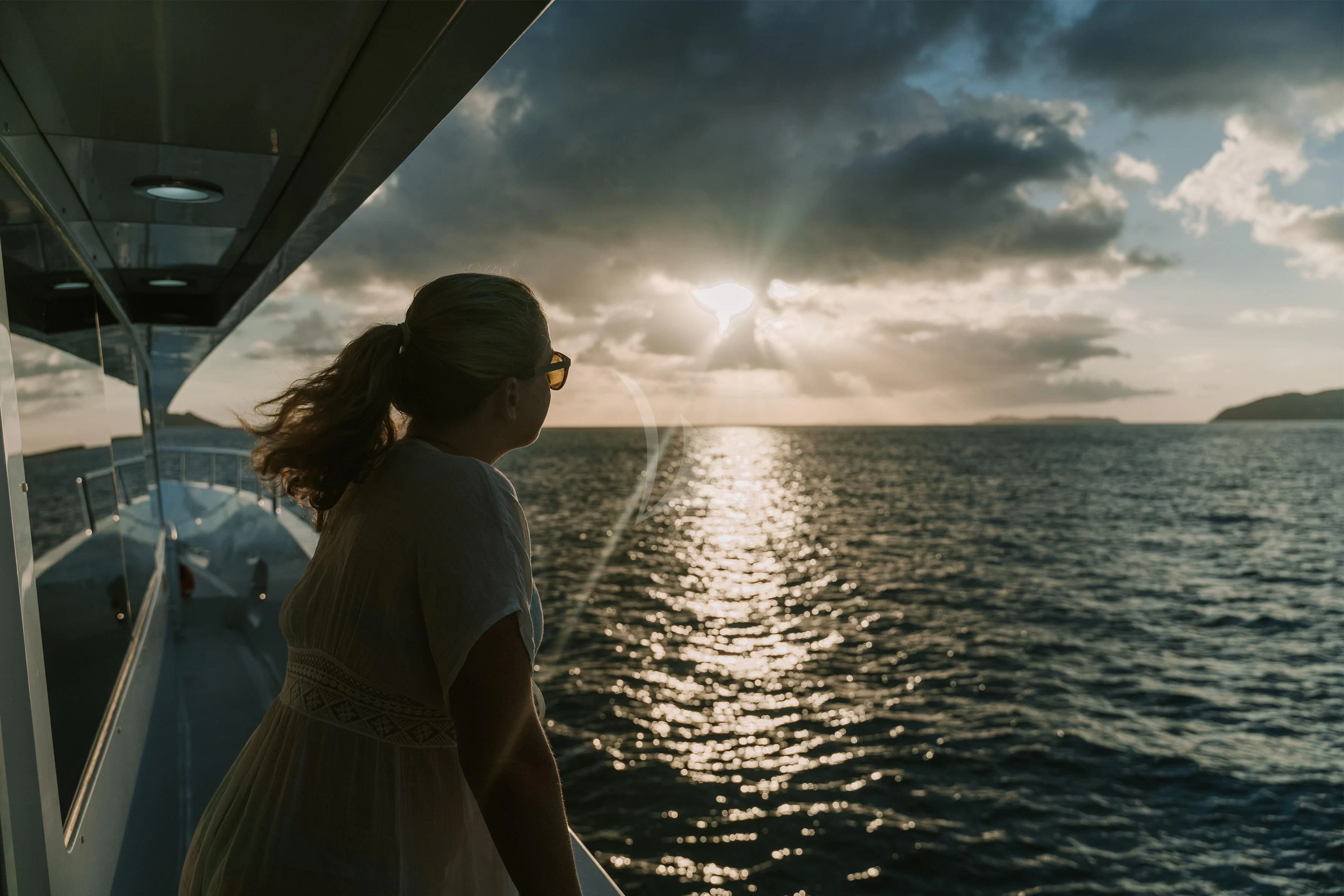 a woman kissing a man on a boat in the water aboard OUTTA TOUCH Yacht for Sale