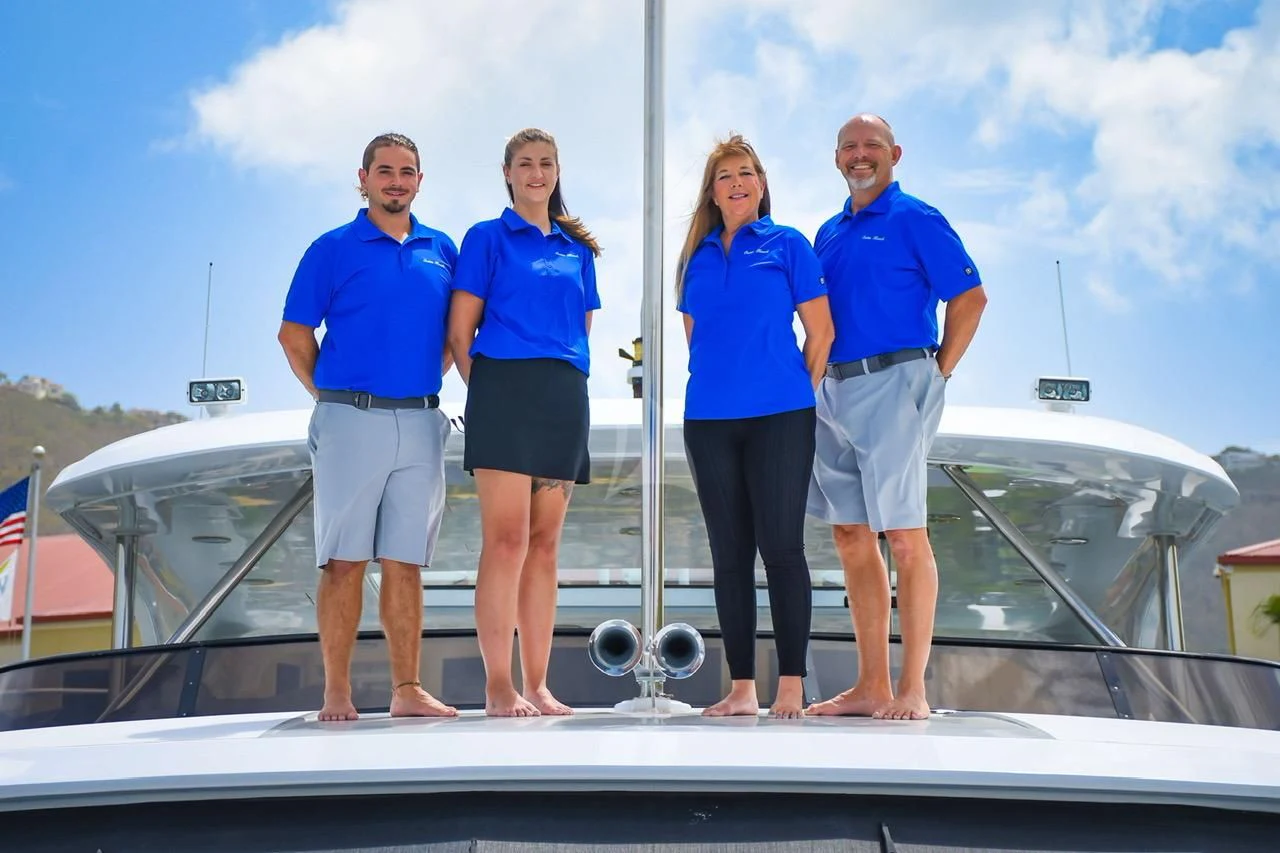 a group of people standing on a boat aboard OUTTA TOUCH Yacht for Sale