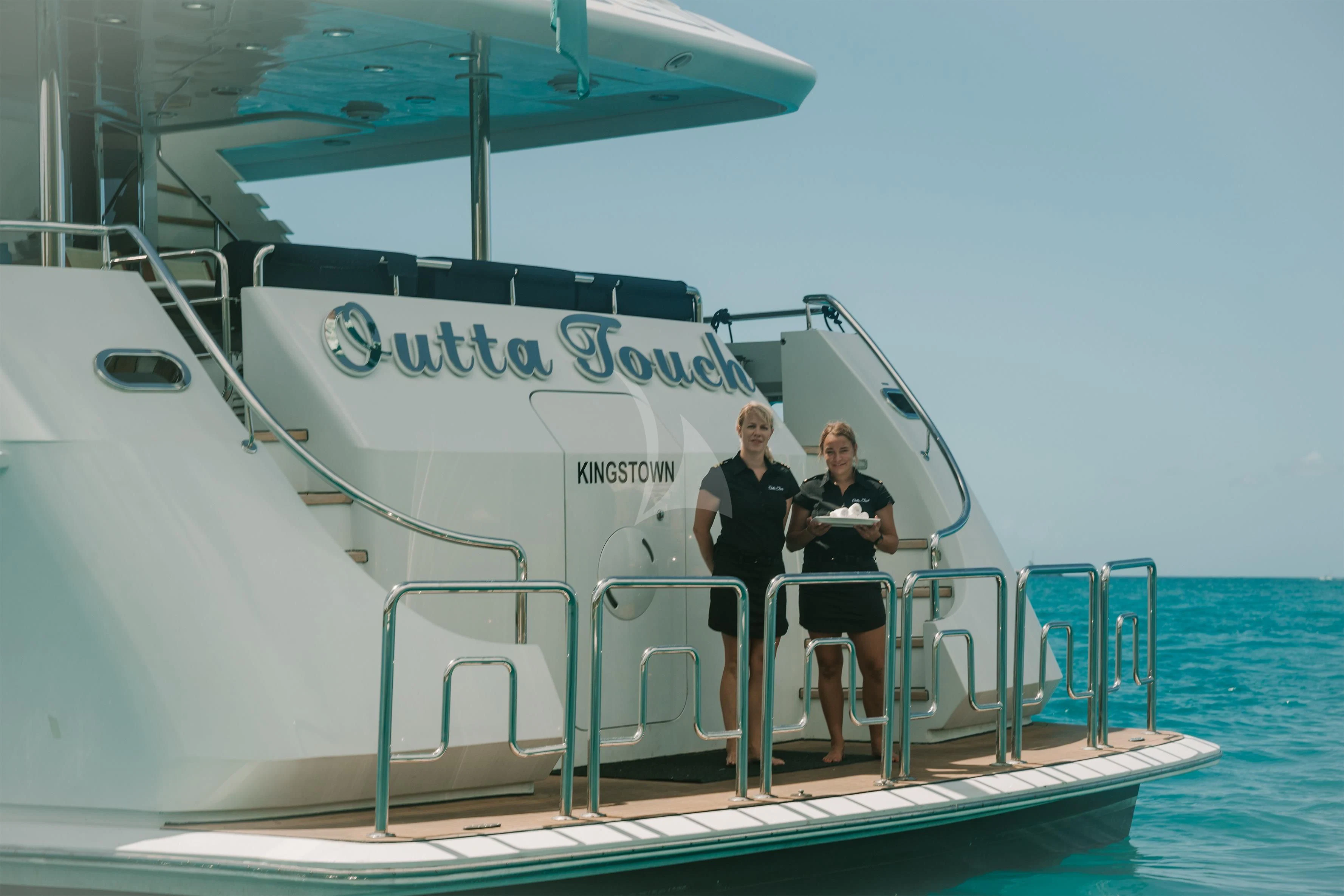 a couple of people standing on a boat aboard OUTTA TOUCH Yacht for Sale