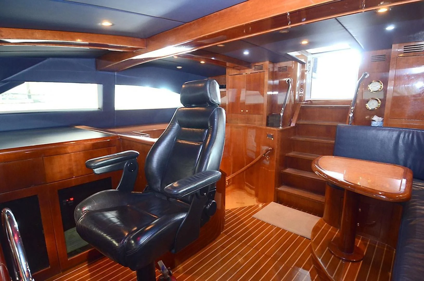 a room with a bench and a table aboard OUTTA TOUCH Yacht for Sale