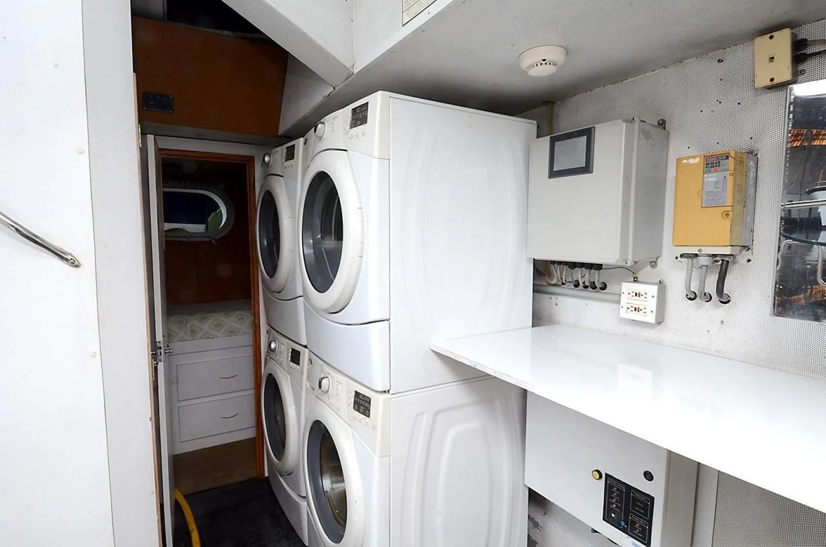a room with a washing machine and cabinets aboard OUTTA TOUCH Yacht for Sale