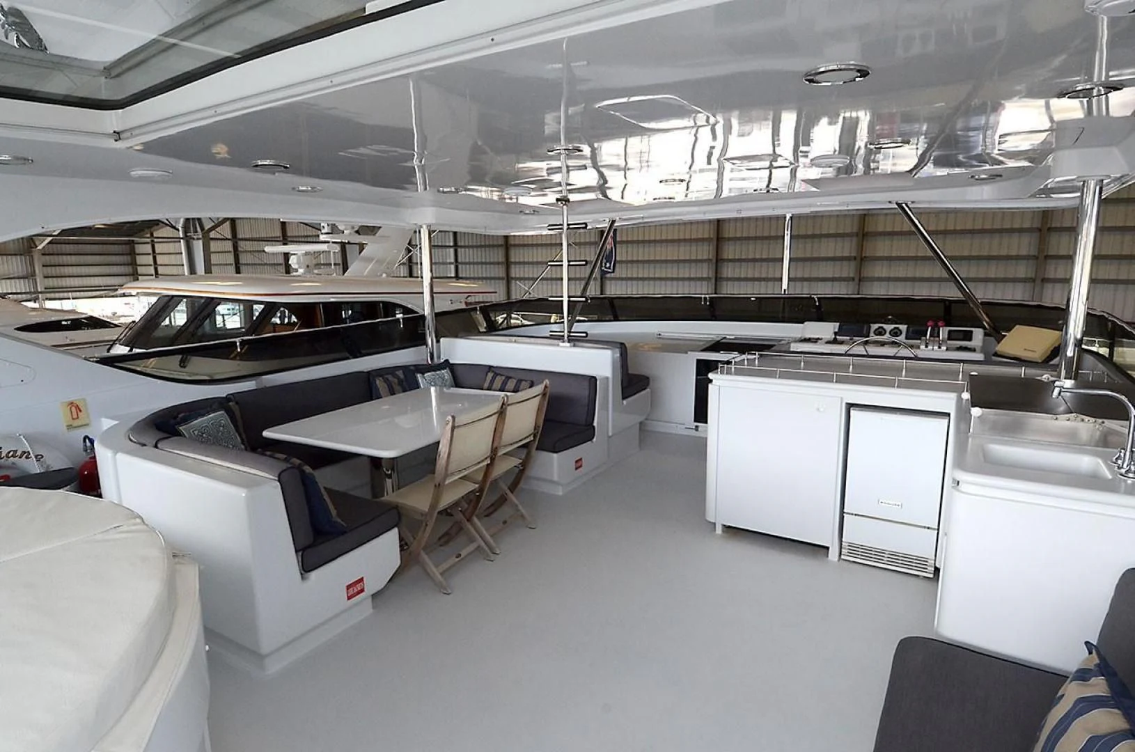a room with tables and chairs aboard OUTTA TOUCH Yacht for Sale
