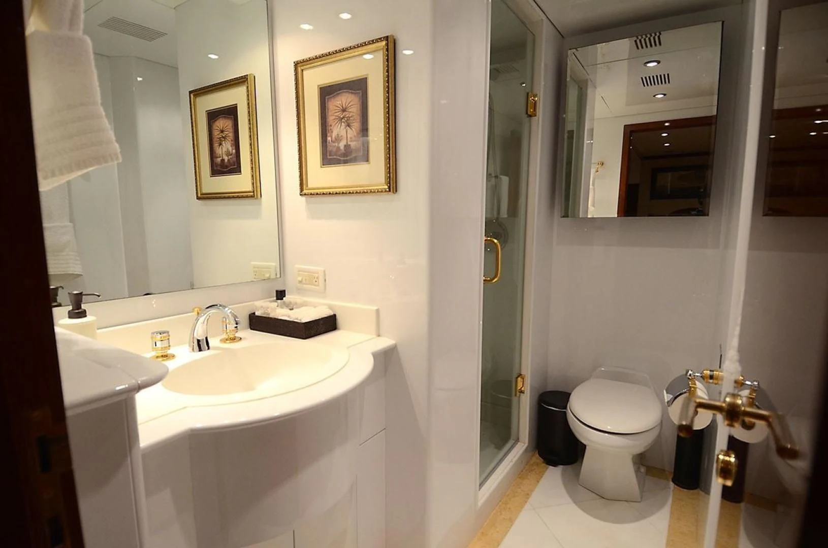 a bathroom with a sink toilet and a mirror aboard OUTTA TOUCH Yacht for Sale