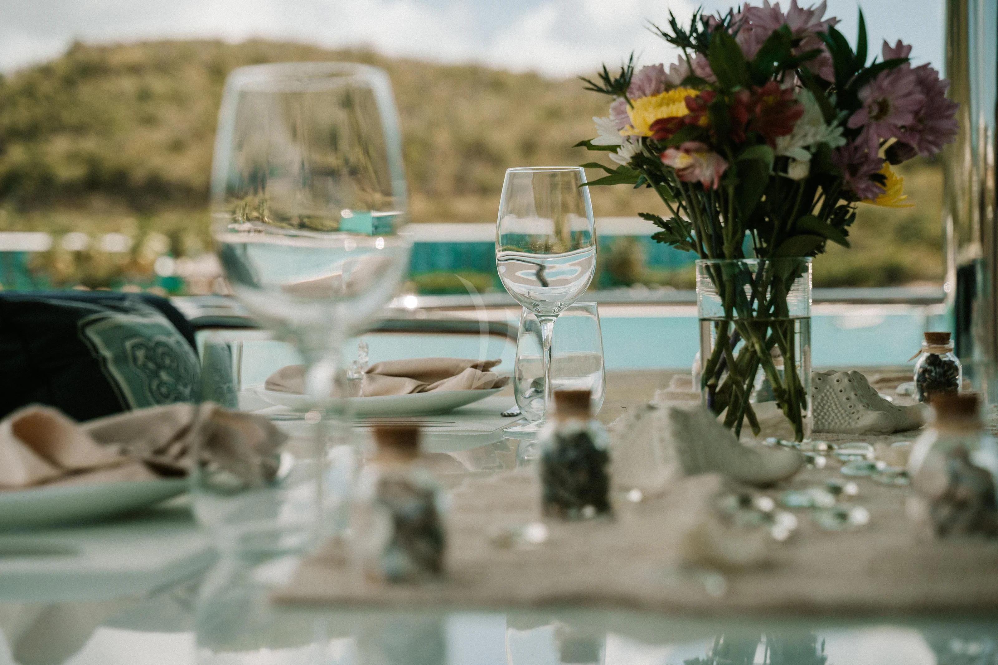 a table with glasses and flowers aboard OUTTA TOUCH Yacht for Sale