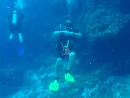 a scuba diver under water aboard OUTTA TOUCH Yacht for Sale