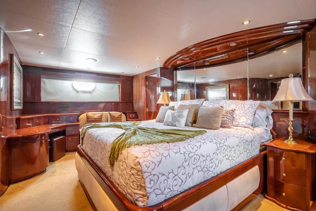 a bedroom with a bed and a desk aboard OUTTA TOUCH Yacht for Sale