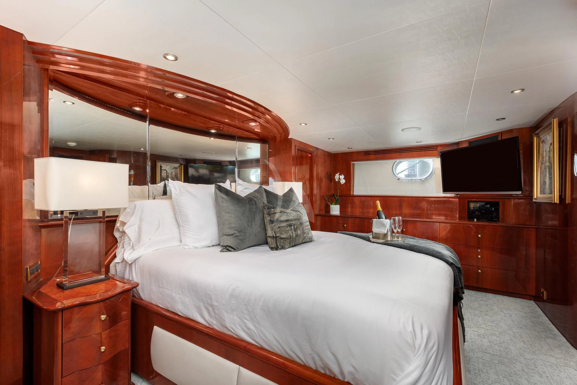 a bedroom with a bed and a television aboard OUTTA TOUCH Yacht for Sale