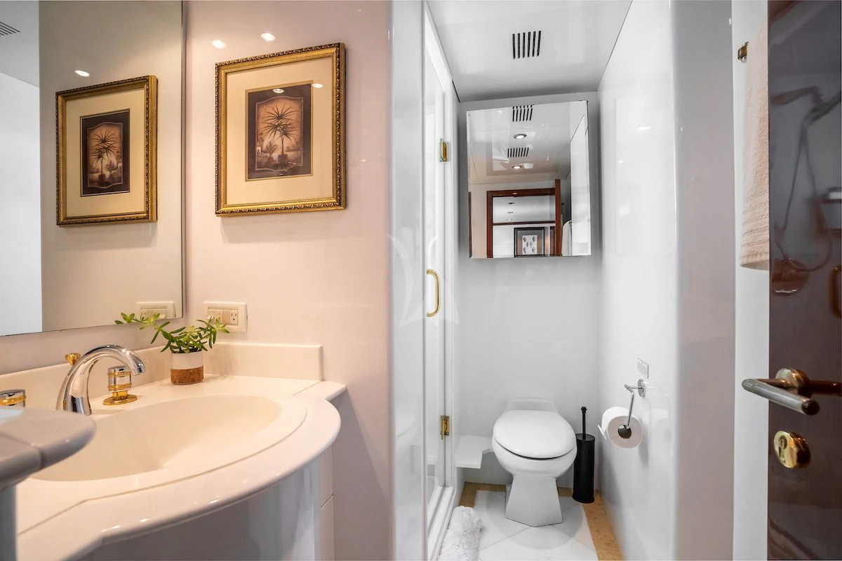 a bathroom with a sink toilet and a mirror aboard OUTTA TOUCH Yacht for Sale