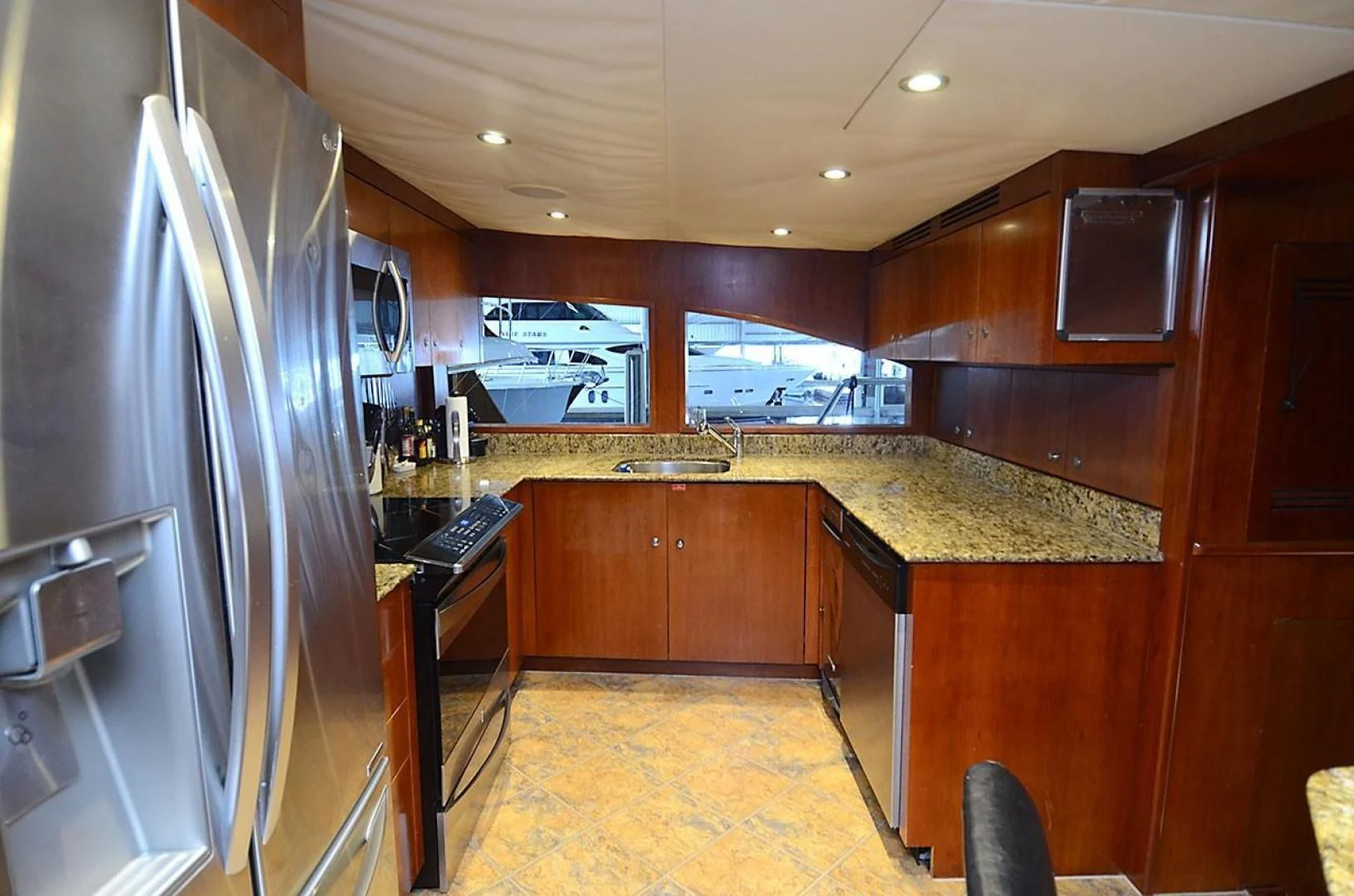 a kitchen with wooden cabinets aboard OUTTA TOUCH Yacht for Sale