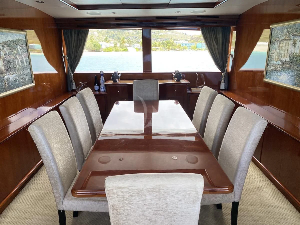 a room with a table and chairs aboard OUTTA TOUCH Yacht for Sale