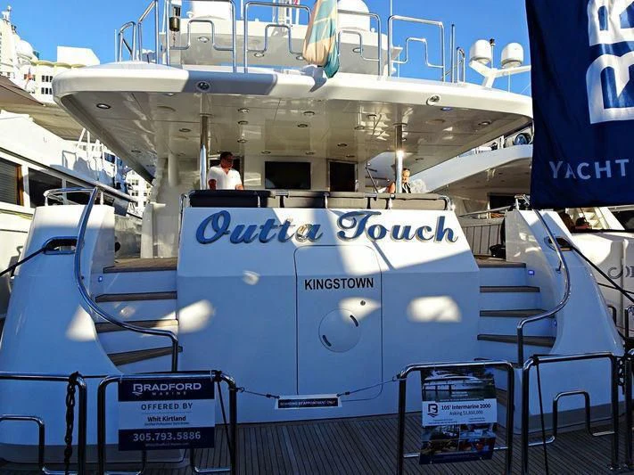 a large white boat with a sign on it aboard OUTTA TOUCH Yacht for Sale
