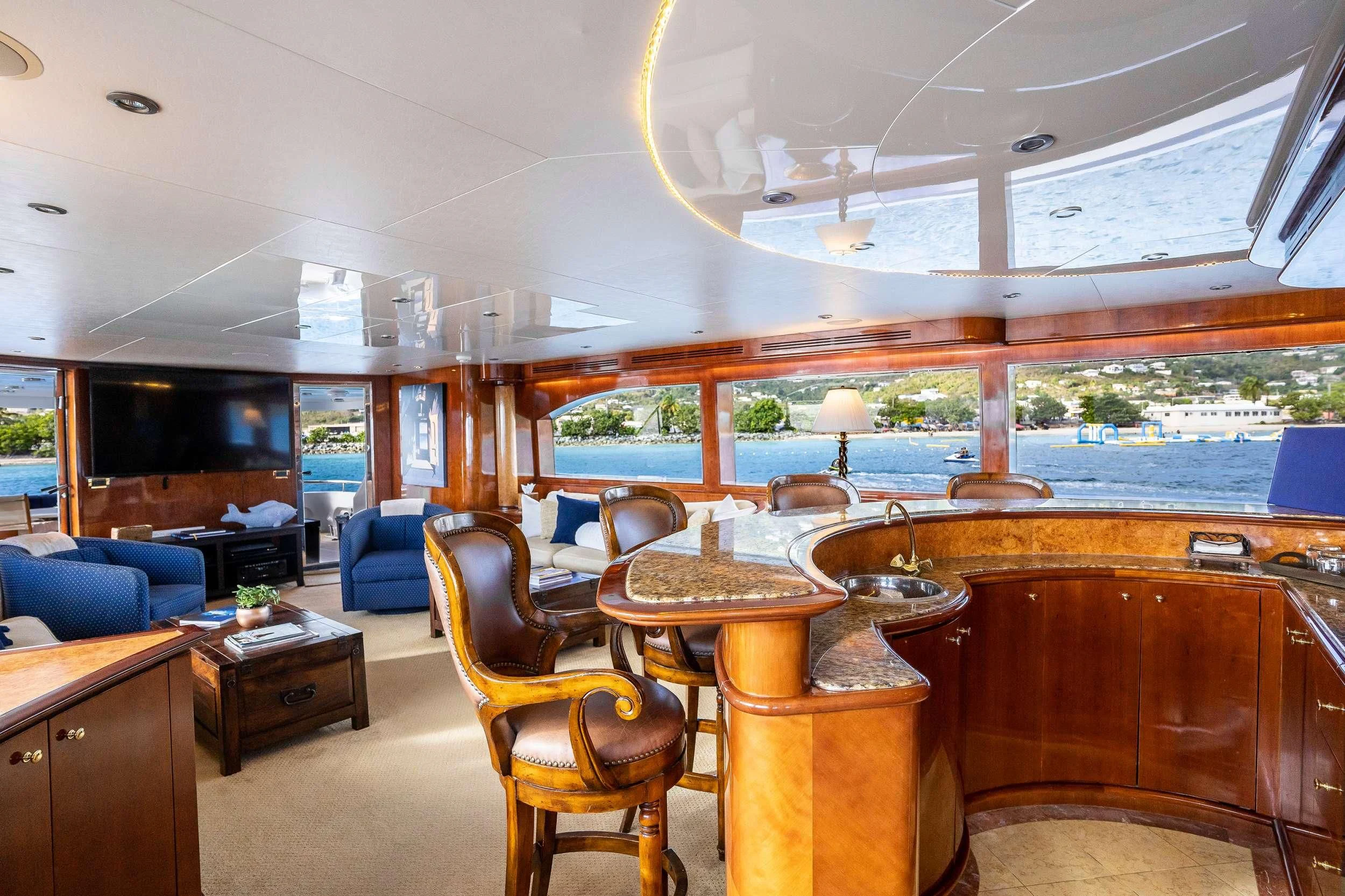 a room with a table chairs and a large window aboard OUTTA TOUCH Yacht for Sale