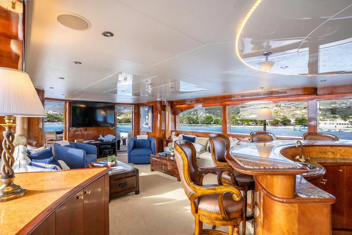a large living room with a kitchen and dining area aboard OUTTA TOUCH Yacht for Sale