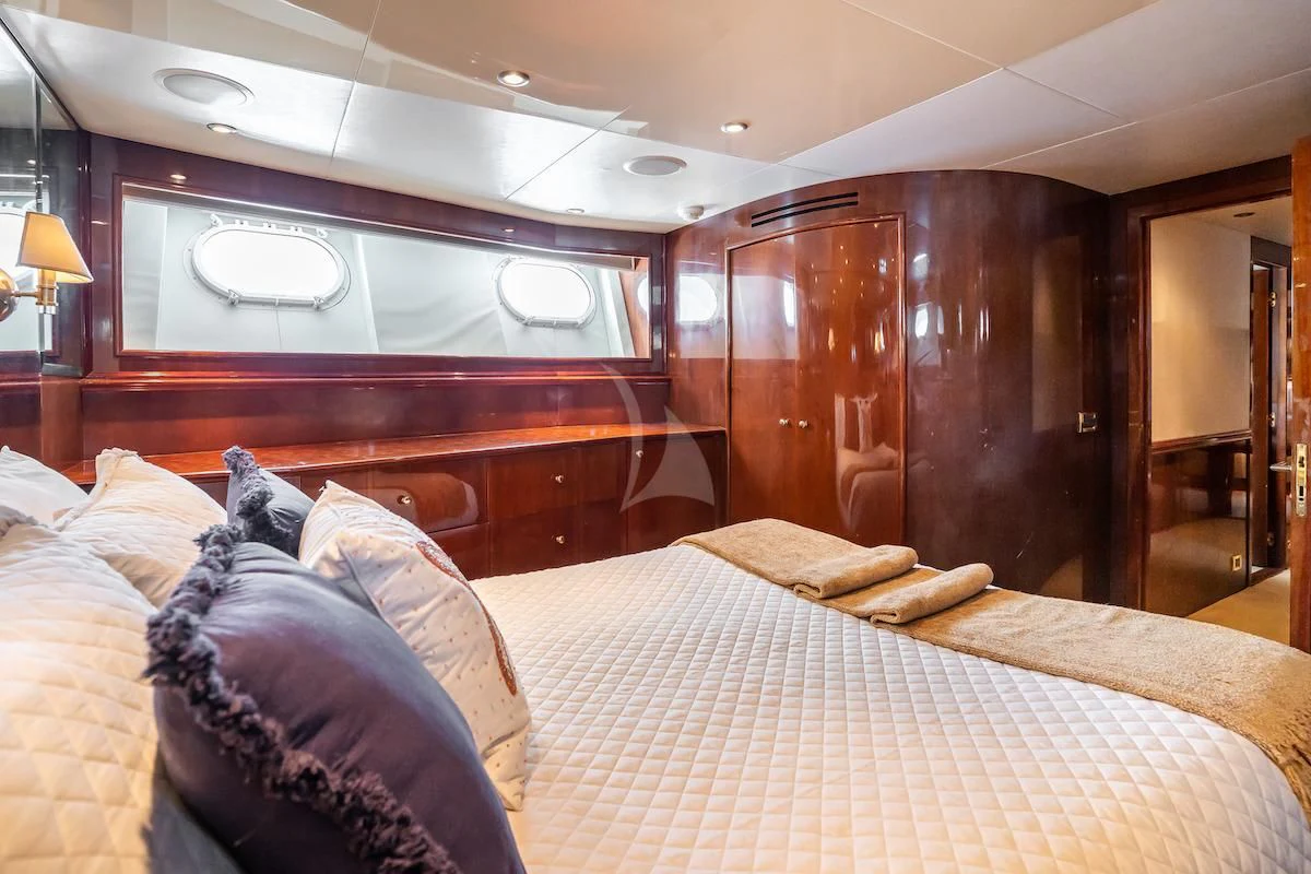 a bed with pillows and a mirror aboard OUTTA TOUCH Yacht for Sale