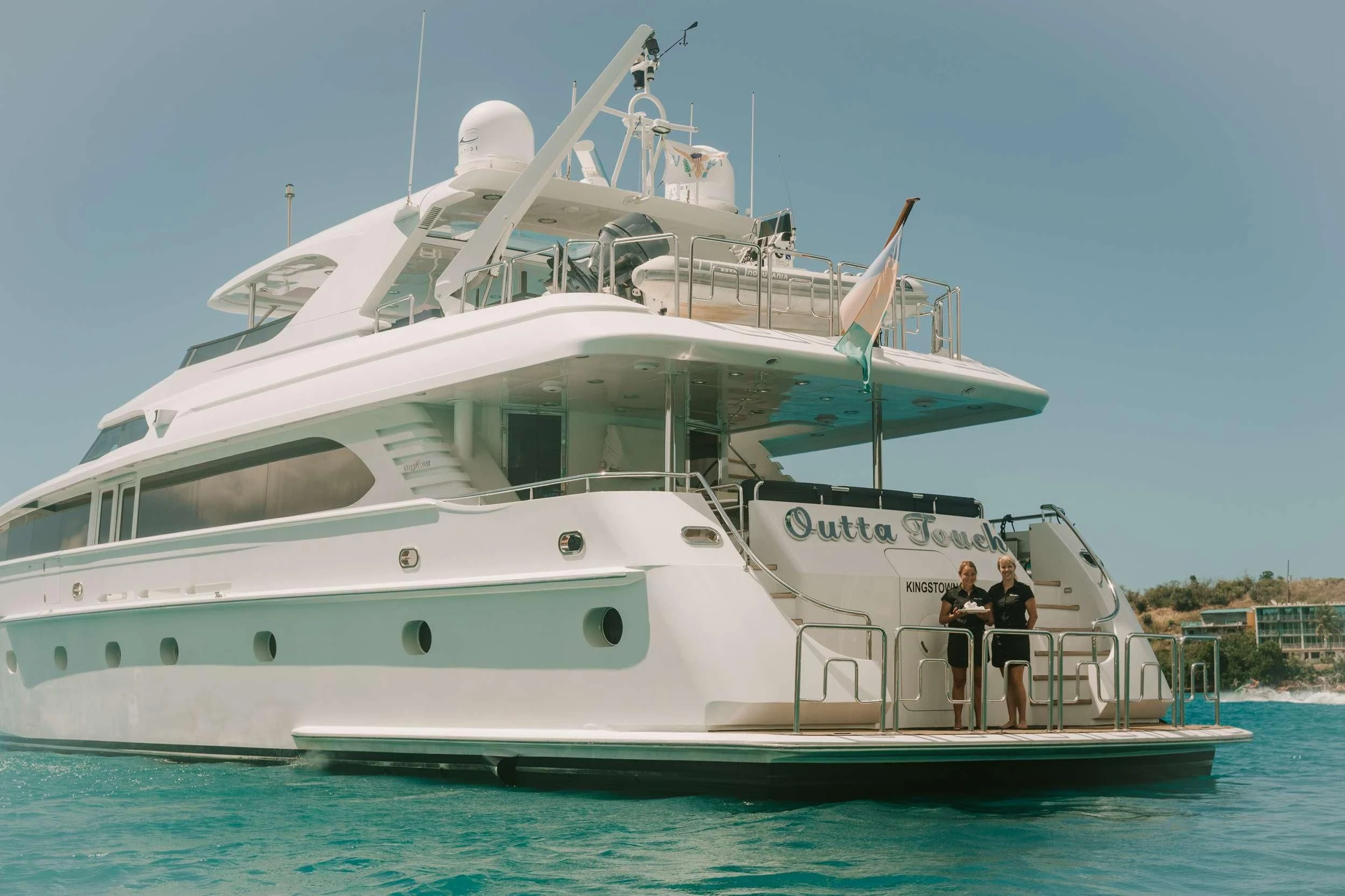 a couple of people standing on a boat aboard OUTTA TOUCH Yacht for Sale
