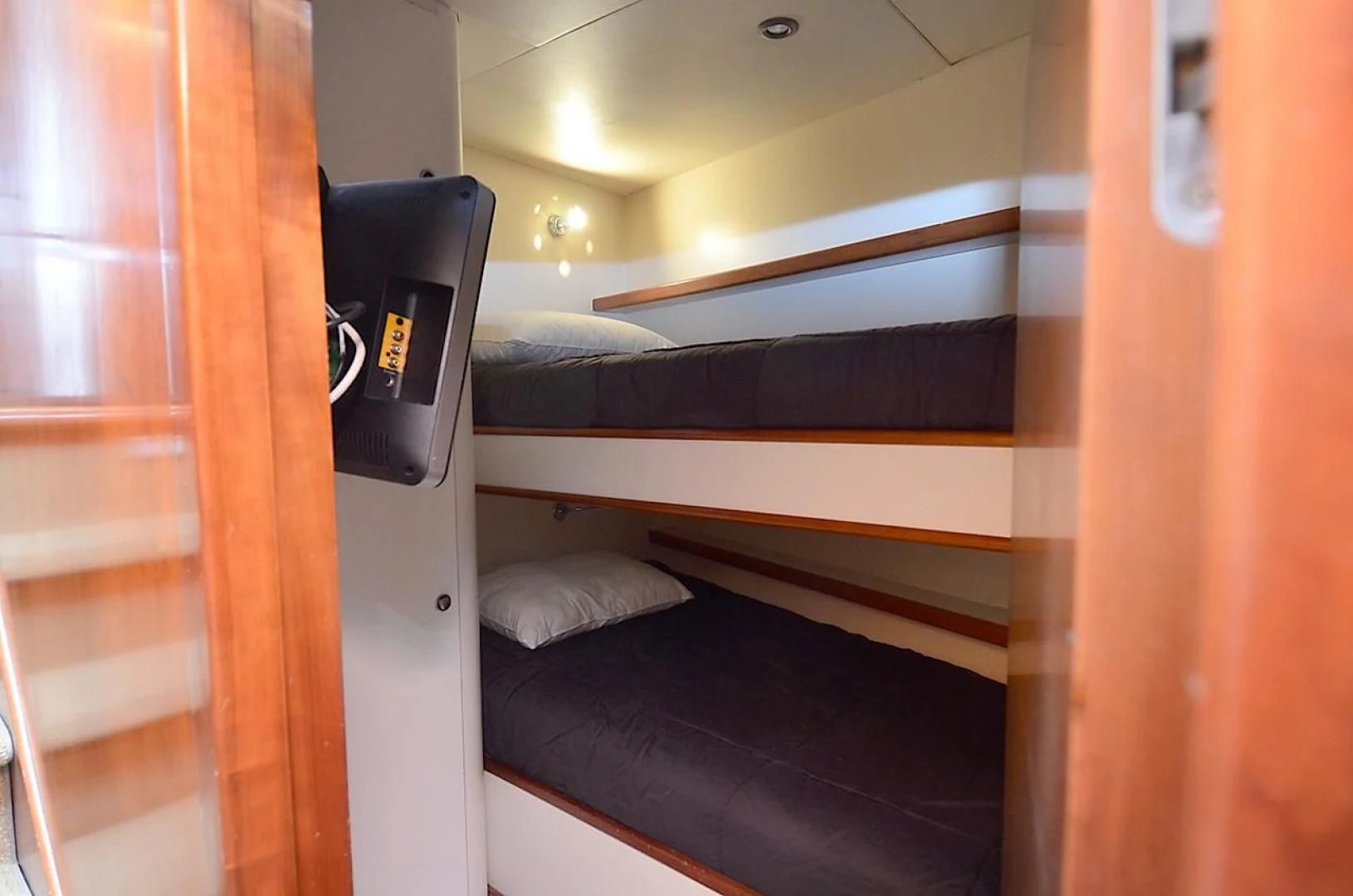 a room with a bed and a desk aboard OUTTA TOUCH Yacht for Sale