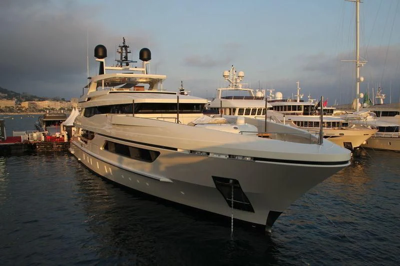 a large white boat in a harbor aboard MR. T Yacht for Charter