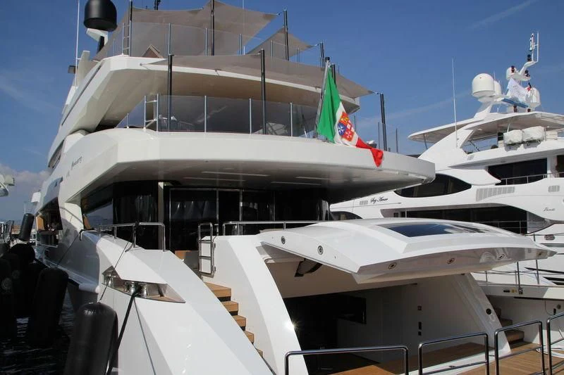 a boat docked with a plane in the background aboard MR. T Yacht for Charter
