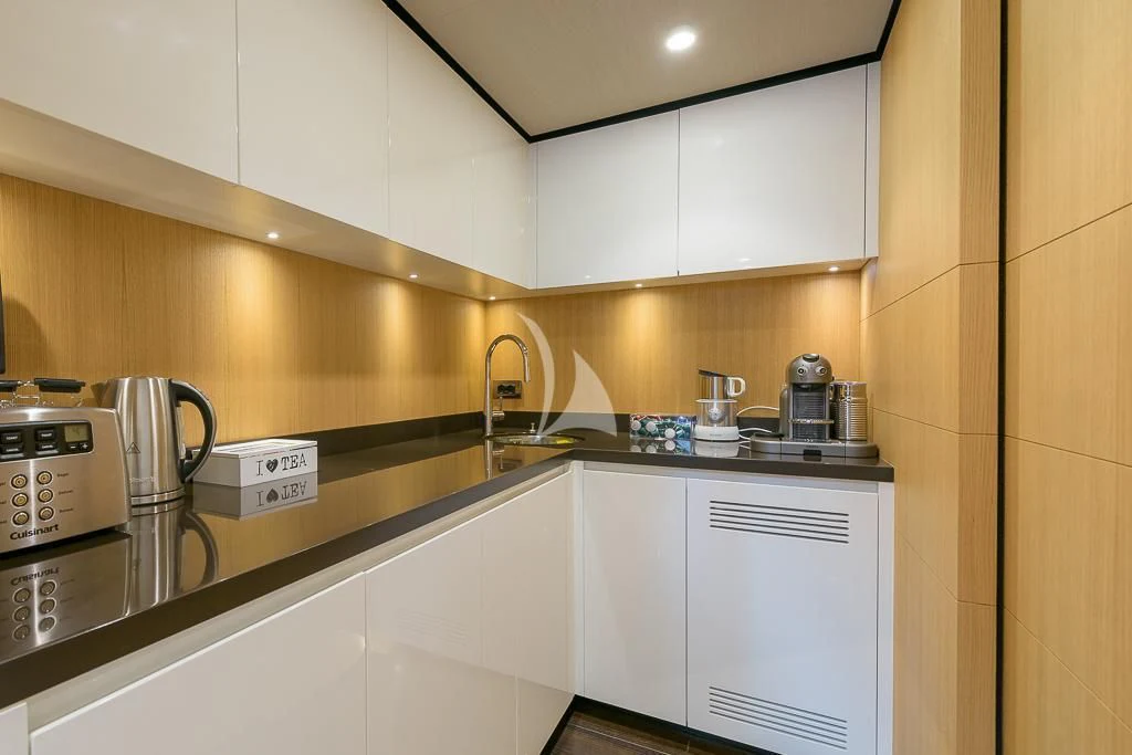a kitchen with white cabinets aboard MR. T Yacht for Charter