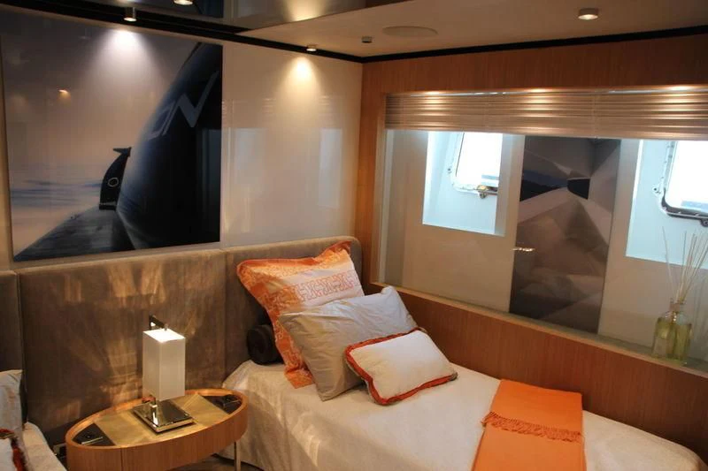 a room with a bed and a mirror aboard MR. T Yacht for Charter